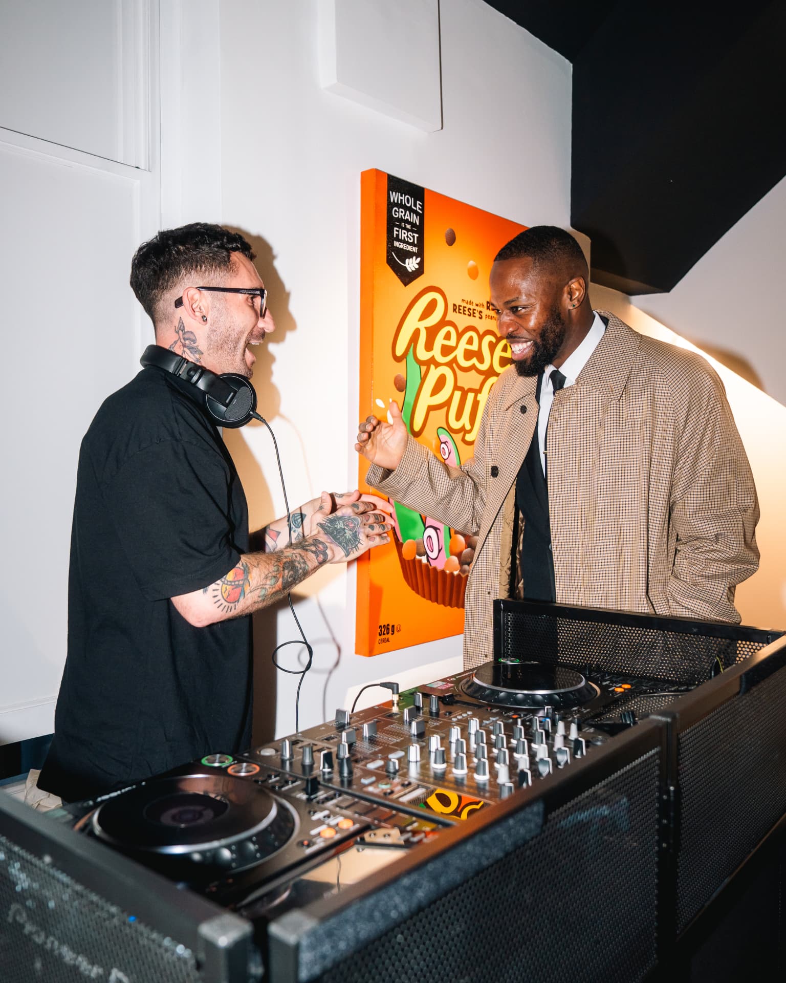DJ greeting a guest at a Waran's Fine Art event