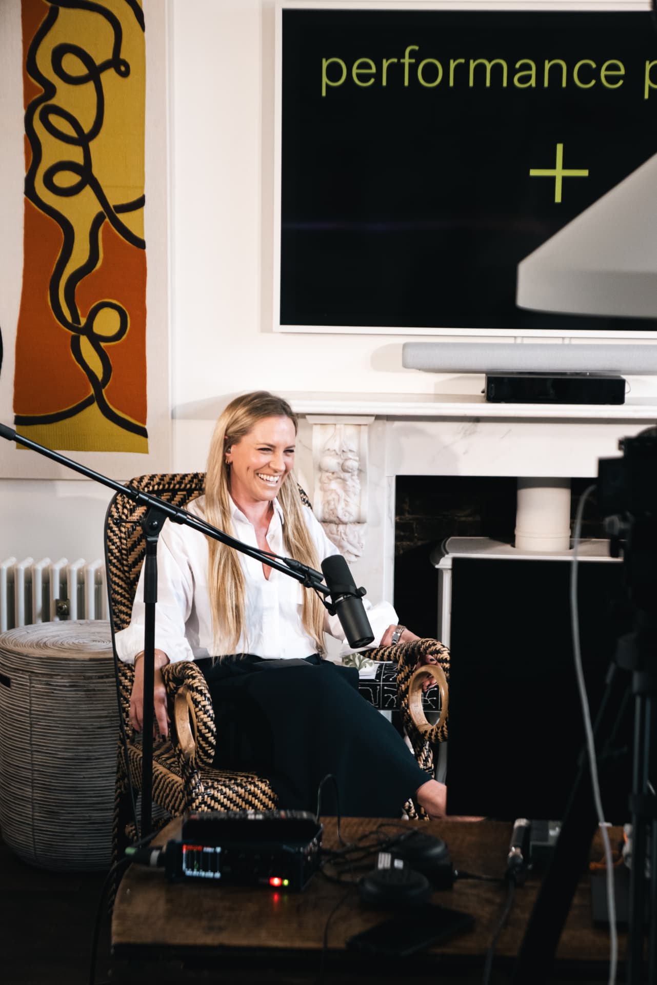 Guest laughing on the Performance People podcast set