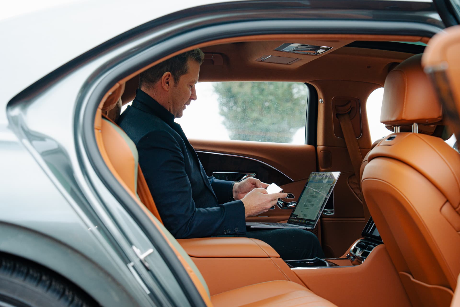 Executive working from the rear cabin of a Bentley
